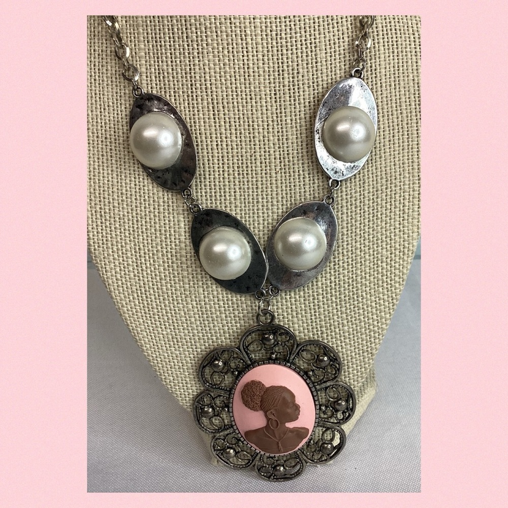 Pink cameo necklace.